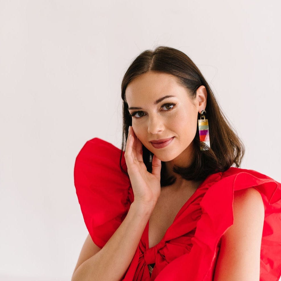 Premium Photo | A woman with a red dress and gold hoop earrings